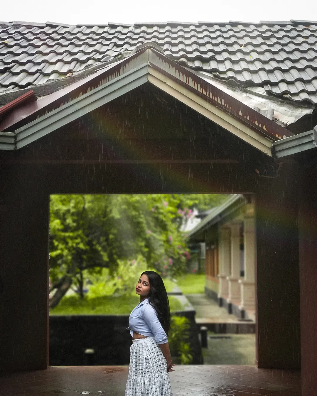 Model framed in the club house archway in the rain