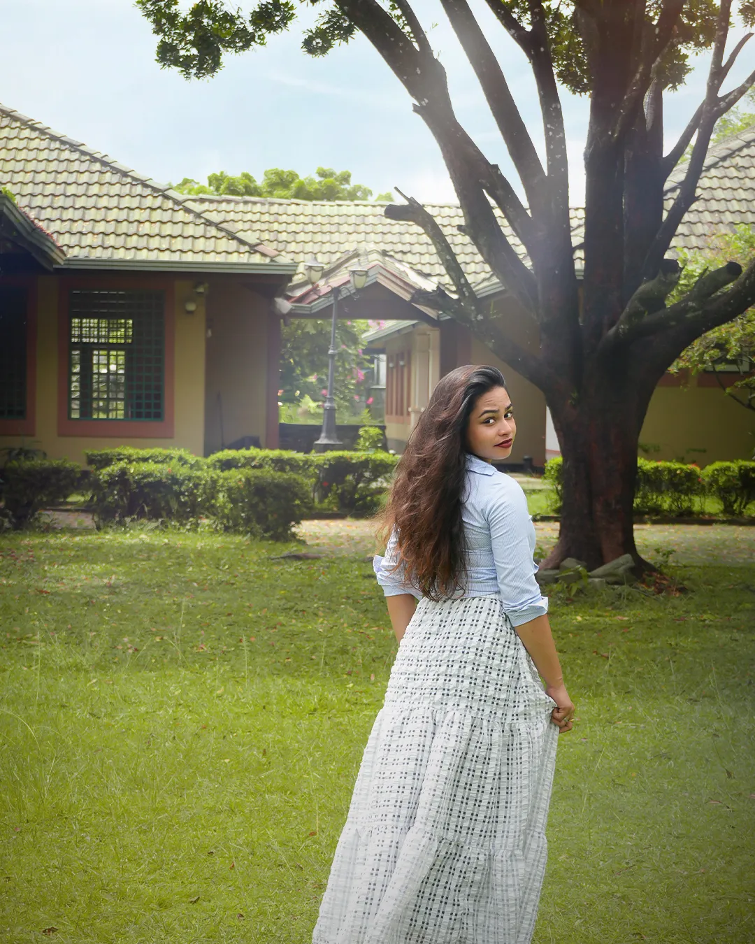 Model in a white period dress on the club house lawn