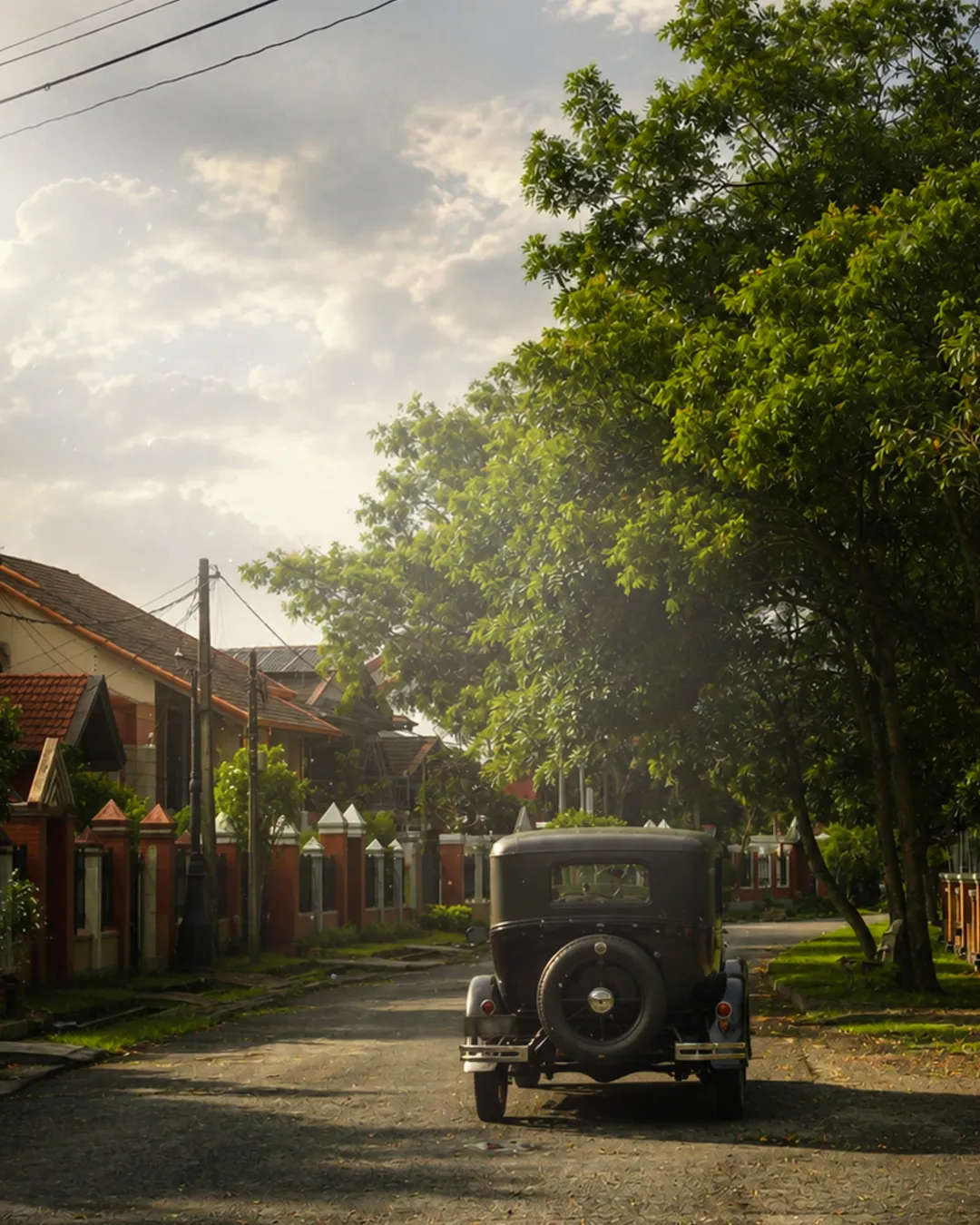 A vintage motorcar parked on a tree-lined street